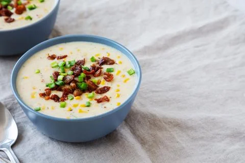 Homemade Corn Chowder with Bacon in Bowls, side view. Space for text. Stock Photos
