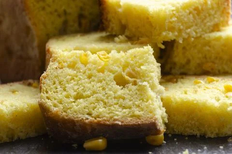 Homemade cornbread slices on kitchen table zoomed image Stock Photos