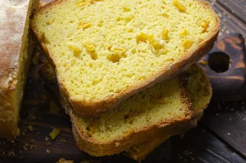 Homemade cornbread slices on kitchen table zoomed image Stock Photos