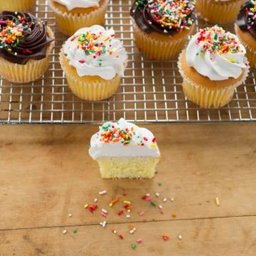 Homemade cupcakes, one with missing bite Stock Photos