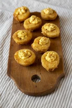 Homemade Deep-fried Deviled Eggs with Paprika on a rustic wooden board, low a 스톡 사진