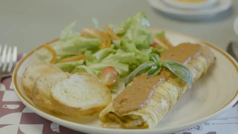 Homemade dish with egg omelet roll, fresh salad and bread. Stock Footage 321704298