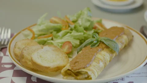 Homemade dish with egg omelet roll, fresh salad and bread. Stock Footage 321704474
