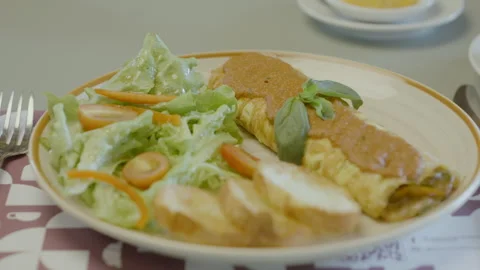 Homemade dish with egg omelet roll, fresh salad and bread Stock Footage 321737184