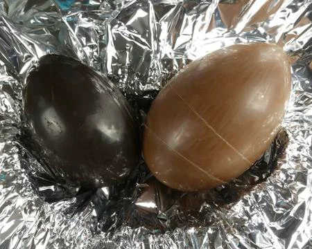 Homemade easter eggs on silver paper background - top view Stock Photos