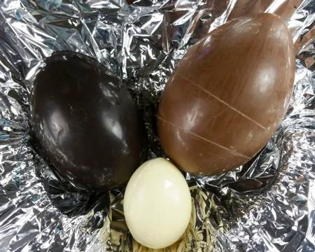 Homemade easter eggs on silver paper background - top view Stock Photos