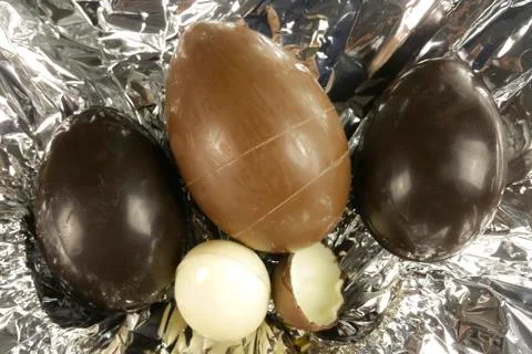 Homemade easter eggs on silver paper background - top view Stock Photos