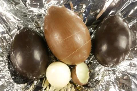 Homemade easter eggs on silver paper background - top view Stock Photos