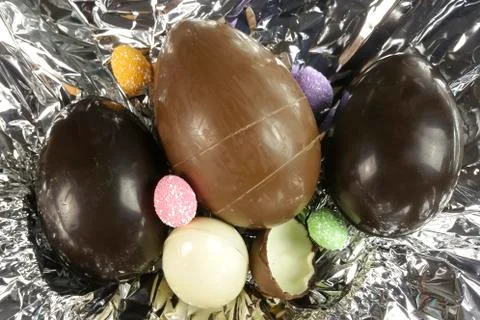 Homemade easter eggs on silver paper background - top view Stock Photos
