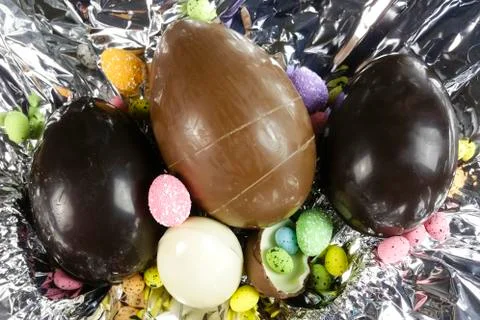 Homemade easter eggs on silver paper background - top view Stock Photos