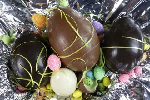 Homemade easter eggs on silver paper background - top view Stock Photos