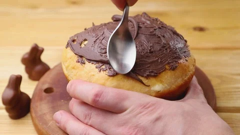Homemade easter pie decorating with chocolate glaze on wooden board. Stock Footage 129777046
