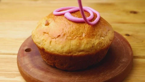 Homemade easter pie decorating with glaze on wooden board. Stock Footage 129777174