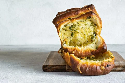 Homemade fresh  pull apart bread with herbs, garlic, cheese and spicy butter Stock Photos