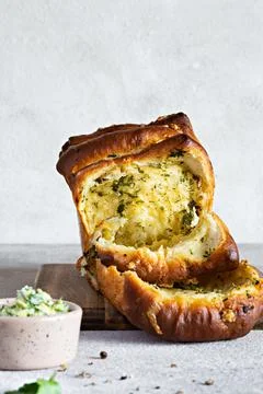 Homemade fresh  pull apart bread with herbs, garlic, cheese and spicy butter Stock Photos