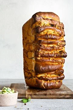 Homemade fresh  pull apart bread with herbs, garlic, cheese and spicy butter Stock Photos