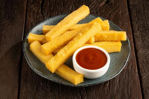 Homemade fried polenta on the table. Stock Photos