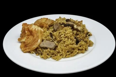Homemade fried rice with sliced grilled lamb and kimchi on a white plate Stock Photos