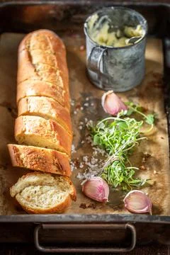 Homemade garlic bread with herbs. Bread with butter and garlic. Stock Photos