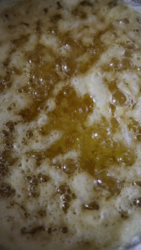 Homemade ghee bubbles and foams while  Stock Footage 344055059
