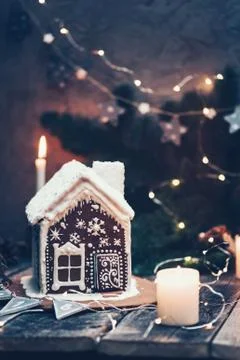 Homemade gingerbread house decorated with candles and Christmas lights Stock Photos