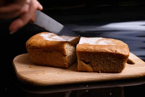 Homemade gray bread on a black background. Photo in section. Stock Photos