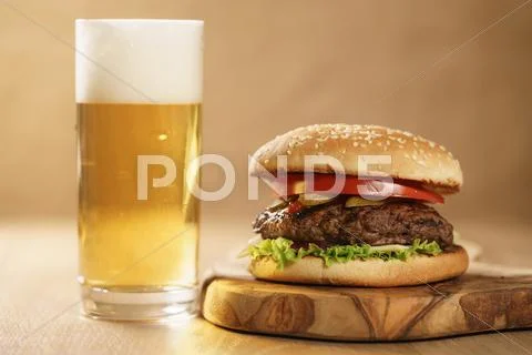 Homemade hamburger with beer on background Stock Photos