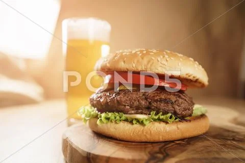 Homemade hamburger with beer on background Stock Photos