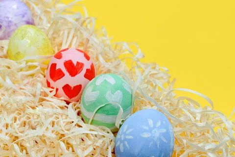 Homemade handmade decorated Easter eggs on paper shavings, traditional handcr Stock Photos