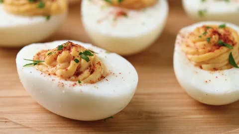 Homemade hard Boiled Deviled Eggs garnished with herbs Video stock 319531208