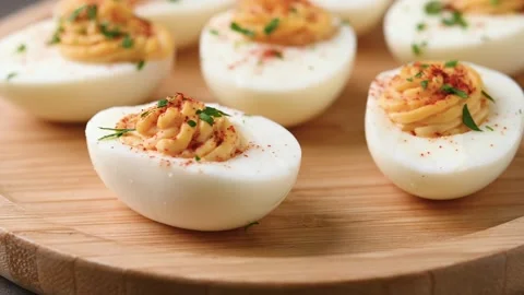 Homemade hard Boiled Deviled Eggs garnished with herbs Video stock 319531218