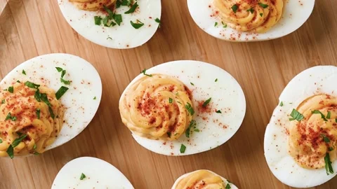 Homemade hard Boiled Deviled Eggs garnished with herbs Video stock 319652961