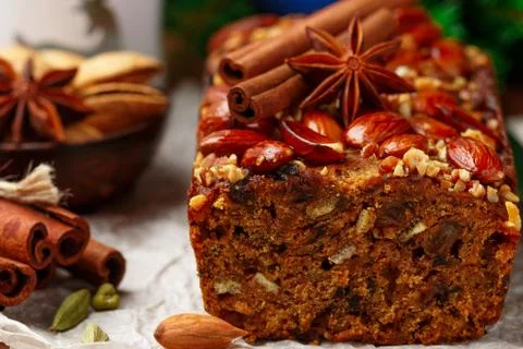 Homemade holiday Fruitcake with nuts, fruits and spices. Almonds, cinnamon, s Stock Photos