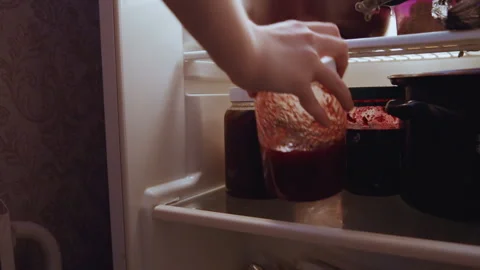 Homemade jam jars arranged on refrigerator shelf. Quiet night scene showing Stock Footage 337452713