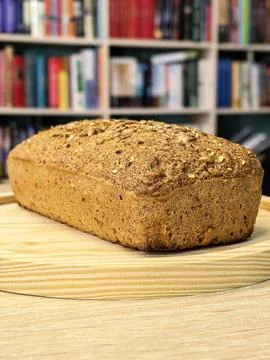 Homemade Keto Seed Bread Loaf Against Bookshelf Background Stock Photos