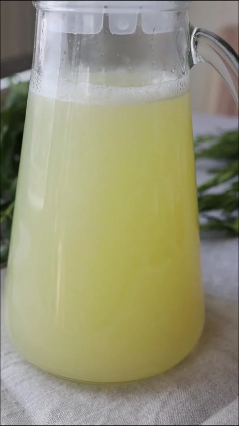 Homemade lemonade with mint, lemon and lime in a glass pitcher on the table Stock Footage 313656557