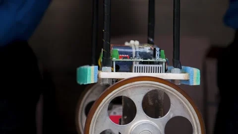 Homemade load carrying robot prototype lifting a mobile phone on its platform Stock-Footage 342768860