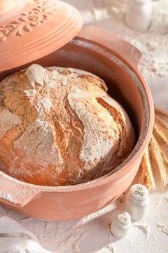 Homemade loaf of bread in a ceramic baking tin. Stock Photos