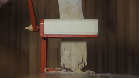Homemade making pasta on a machine for cutting pasta. Stock Footage 129234243