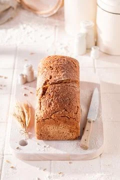 Homemade oat bread baked in a rustic bright kitchen. Stock Photos