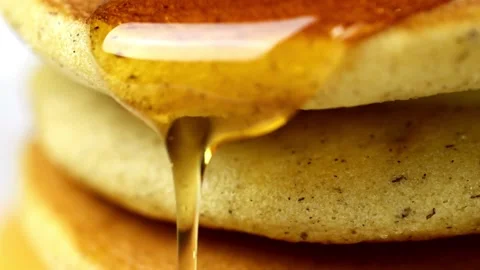 Homemade Pancake for easy breakfast. Maple syrup being poured over pancakes. Stock-Footage 336589000
