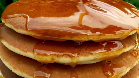 Homemade Pancake for easy breakfast. Maple syrup being poured over pancakes. Stock-Footage 336589225
