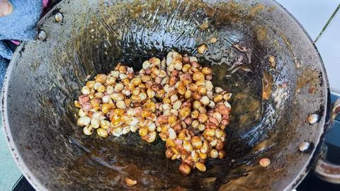 Homemade Peanut Brittle Preparation Using Roasted Peanuts and Melted Jaggery Stock Photos