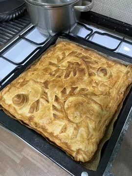 Homemade pie with patterns on black protvin Stock Photos