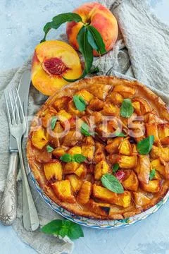 Homemade pie with peaches and fresh mint. Stock Photos