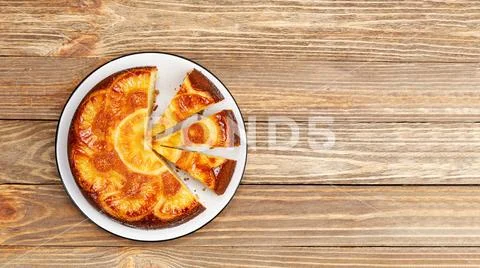 Homemade Pineapple Upside Down Cake on wooden table. Top view. Copyspace. Stock Photos