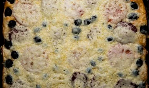 Homemade pizza with cheese tomatoes ham Stock Photos