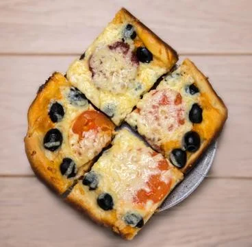 Homemade pizza with ham cheese olives tomatoes on wooden table Stock Photos