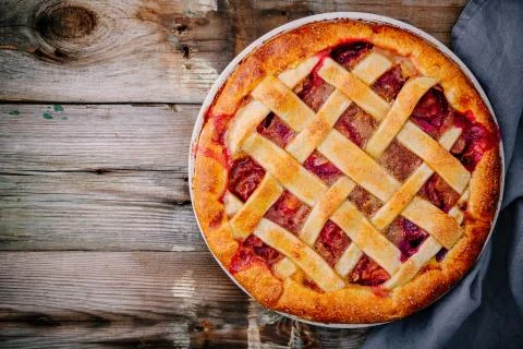 Homemade plum pie on rustic background Stock Photos