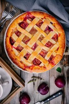 Homemade plum pie on rustic background Stock Photos
